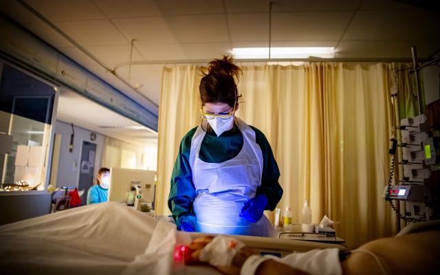 Verpleegster aan bed patiënt