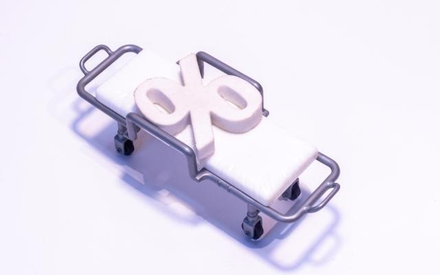 Illustratie van een brancard met een procentteken erop