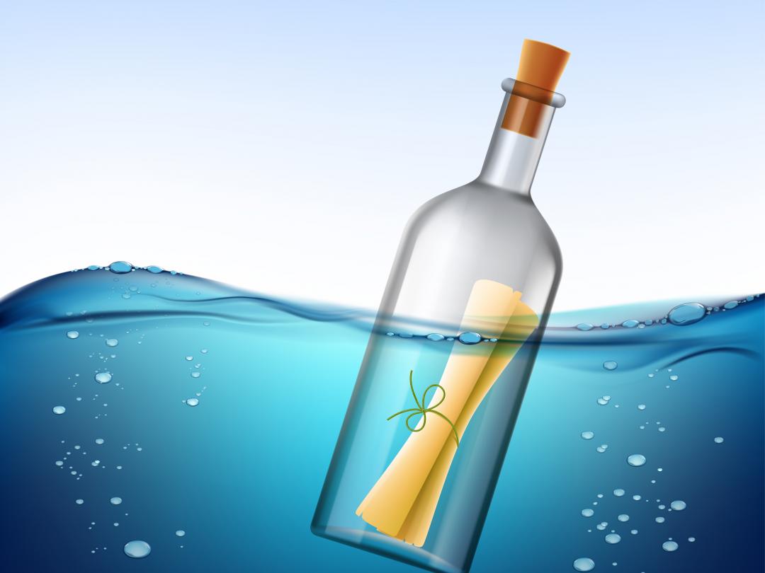 Een opgerolde brief in een lege wijnfles drijft in het water.