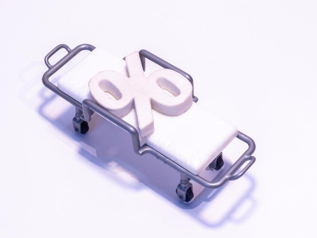 Illustratie van een brancard met een procentteken erop